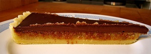 Chocolate tart with frangipane in the center. Frangipane is a filling made from or flavored like almonds