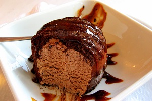 Tartufo. Chocolate gelato with a core of vanilla gelato, and covered in chocolate and syrup