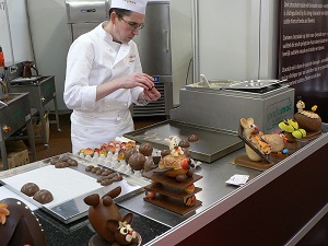 Chocolatier assembling chocolate eggs, Choco-Laté fair, Brugge, Belgium