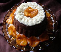 Steamed persimmon pudding with nutmeg hard sauce and candied persimmon slices