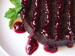 Chocolate custard cake with raspberry-pomegranate sauce